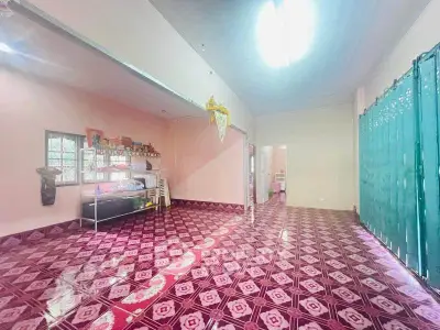 Spacious open-plan living area with vibrant tiled flooring and ample natural light.