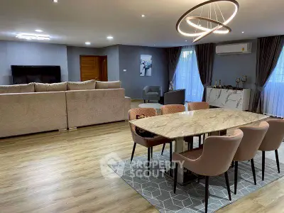 Spacious modern living room with elegant dining area and stylish lighting