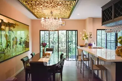 Luxurious dining room with elegant chandelier and open kitchen layout
