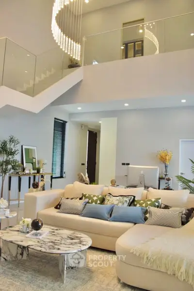 Luxurious modern living room with elegant chandelier and stylish decor