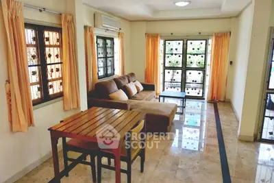 Spacious living room with elegant marble flooring and cozy seating area