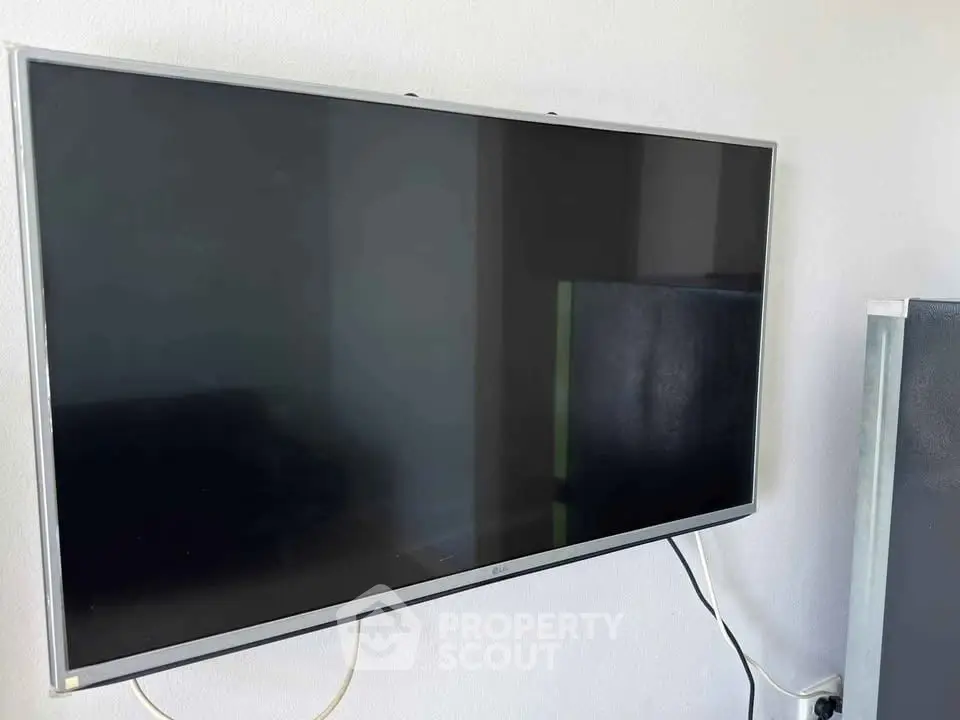 Modern wall-mounted flat-screen TV in a sleek interior setting.