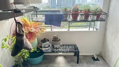 Charming balcony with potted plants and city view, perfect for relaxation and urban gardening.