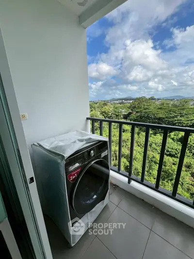 Scenic balcony with lush green view and modern washing machine, perfect for serene living.