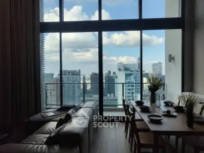 Stunning high-rise living room with floor-to-ceiling windows and city skyline view.
