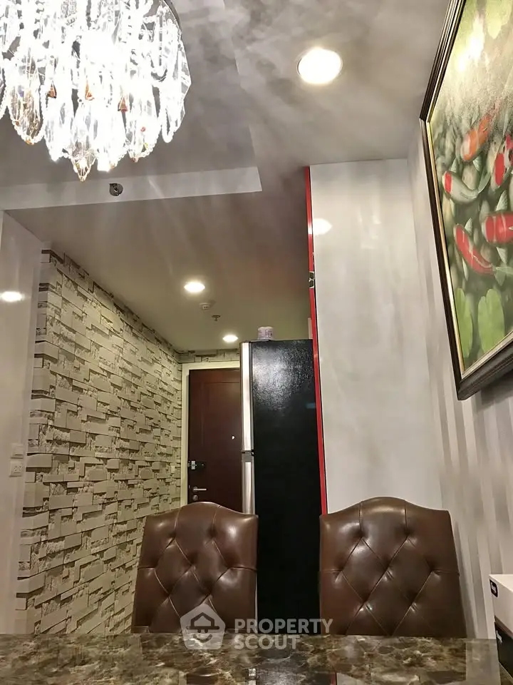 Elegant dining area with chandelier and modern decor in a stylish apartment.