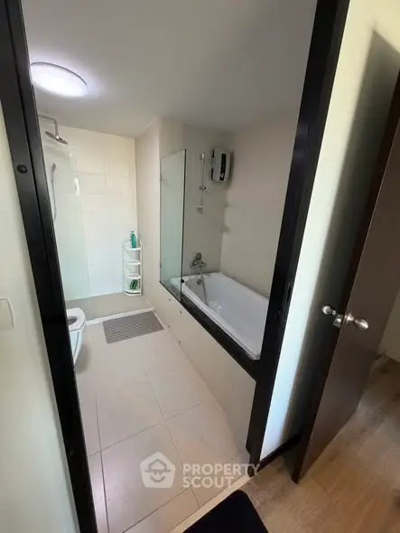 Modern bathroom with bathtub and shower in sleek apartment