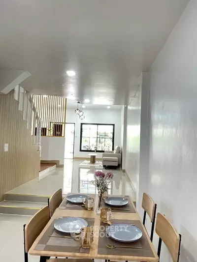 Modern open-plan living and dining area with stylish decor and natural light