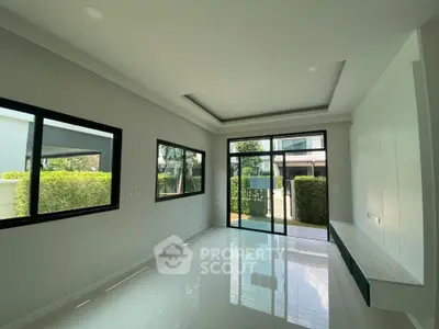 Spacious modern living room with large windows and garden view