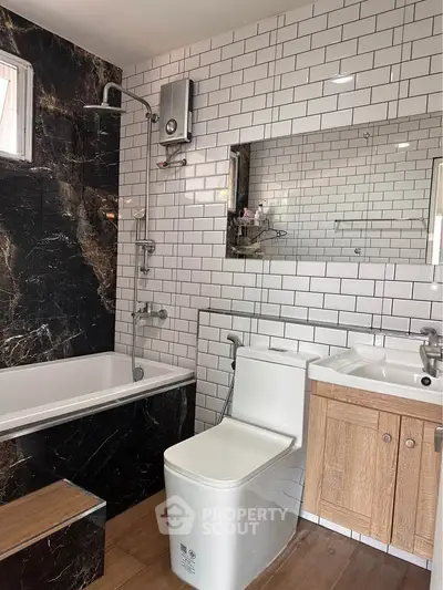 Modern bathroom with bathtub, sleek fixtures, and stylish tile design.