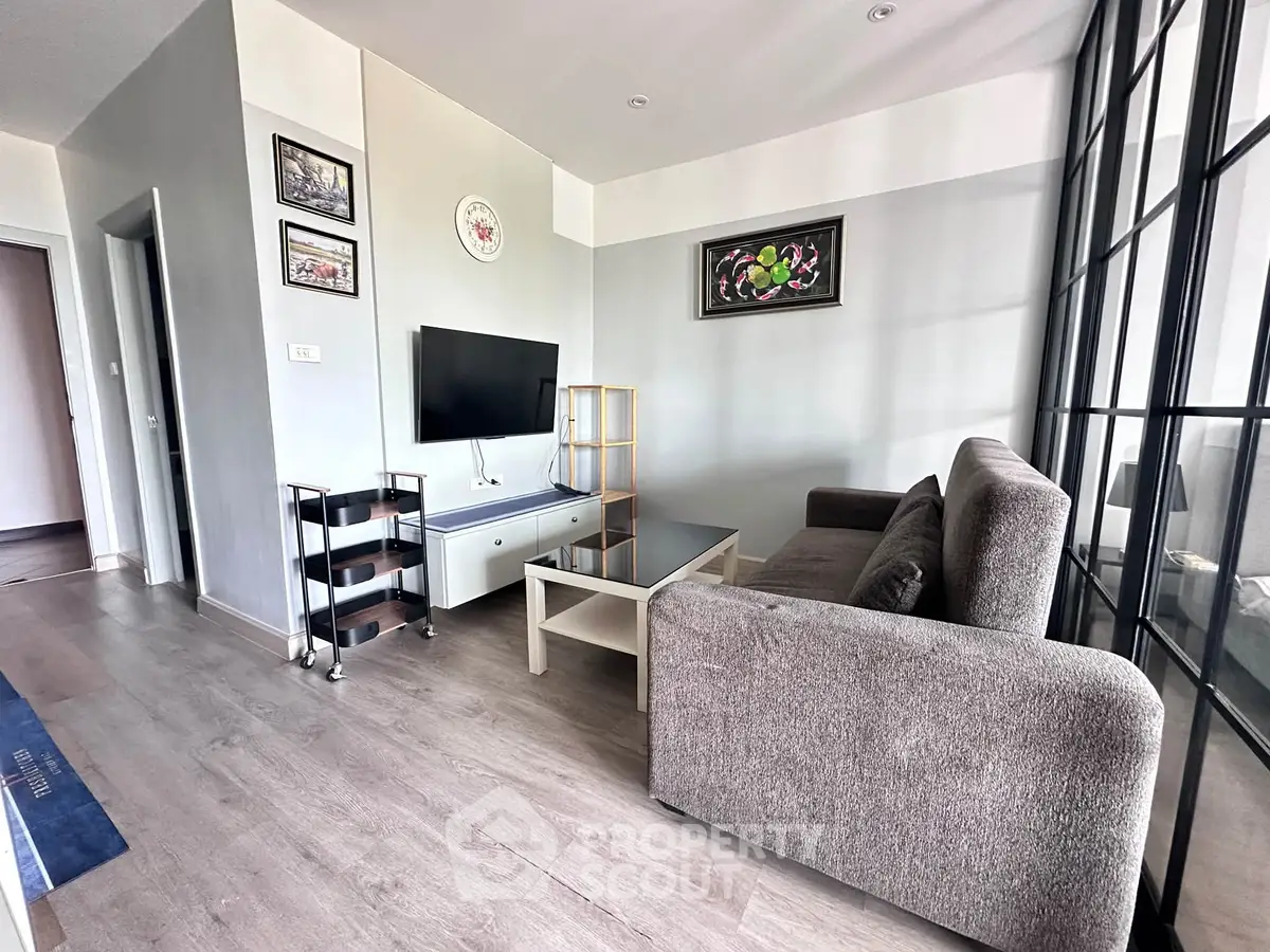 Modern living room with stylish decor and large windows in a contemporary apartment.