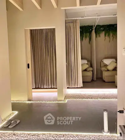 Luxurious spa-like interior with ambient lighting and cozy seating area, perfect for relaxation and tranquility.