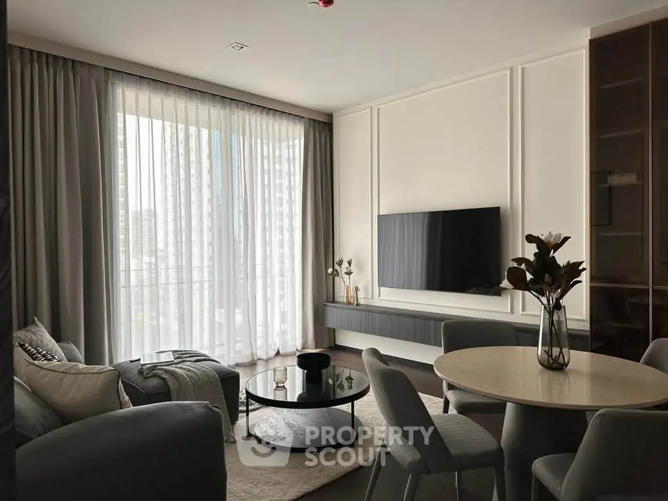 Modern living room with elegant decor and large window offering city view