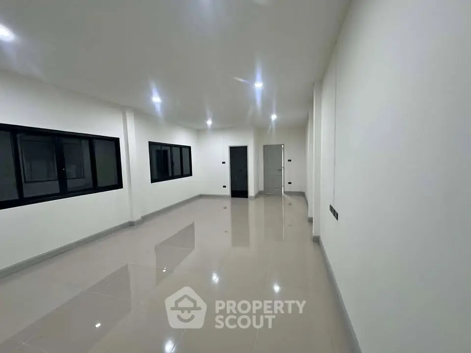 Spacious modern living room with sleek tile flooring and recessed lighting