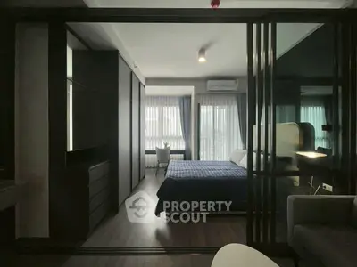 Modern bedroom with sleek design and large windows offering natural light.