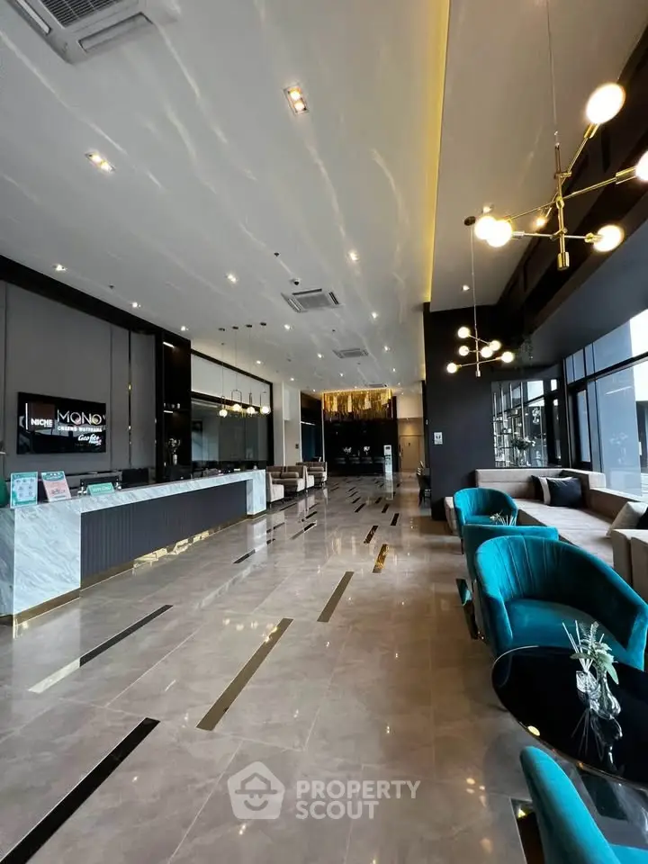 Luxurious modern lobby with elegant seating and marble flooring in upscale building.