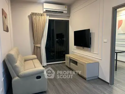 Modern living room with sleek furniture and city view balcony