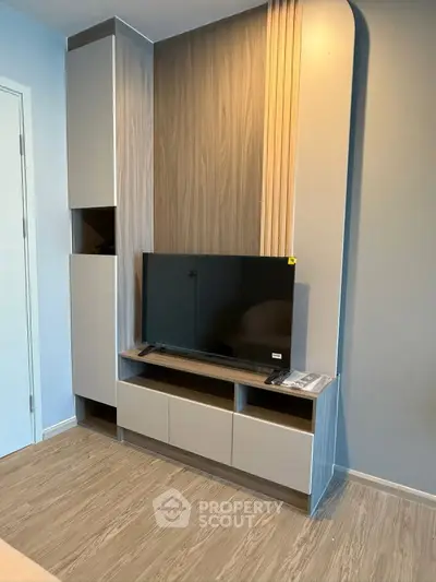 Modern living room with sleek TV unit and stylish wood paneling