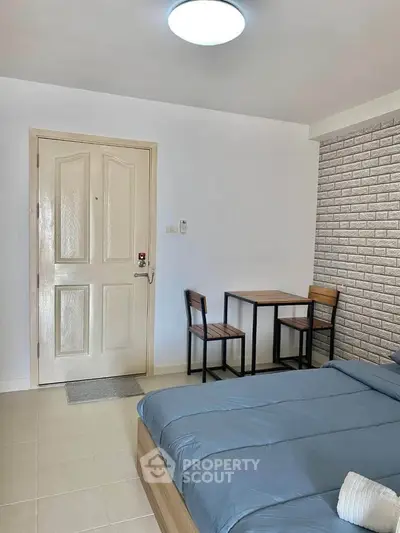 Cozy bedroom with modern decor and small dining area