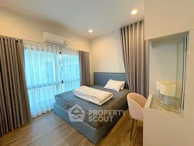 Modern bedroom with stylish decor and natural light