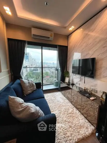 Modern living room with city view, plush sofa, and sleek TV setup in a stylish apartment.