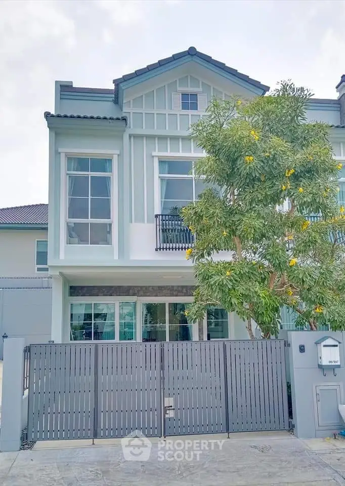 Charming modern townhouse with stylish facade and lush front garden