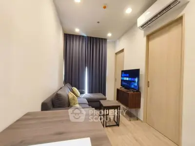 Modern living room with sleek furniture and air conditioning in a cozy apartment.