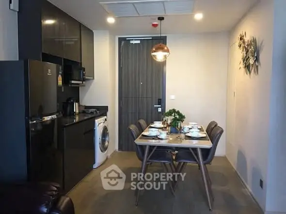 Modern kitchen with dining area featuring sleek appliances and stylish decor