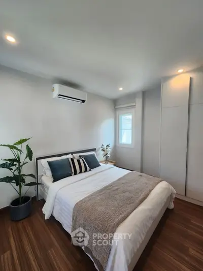 Modern bedroom with stylish decor and natural light