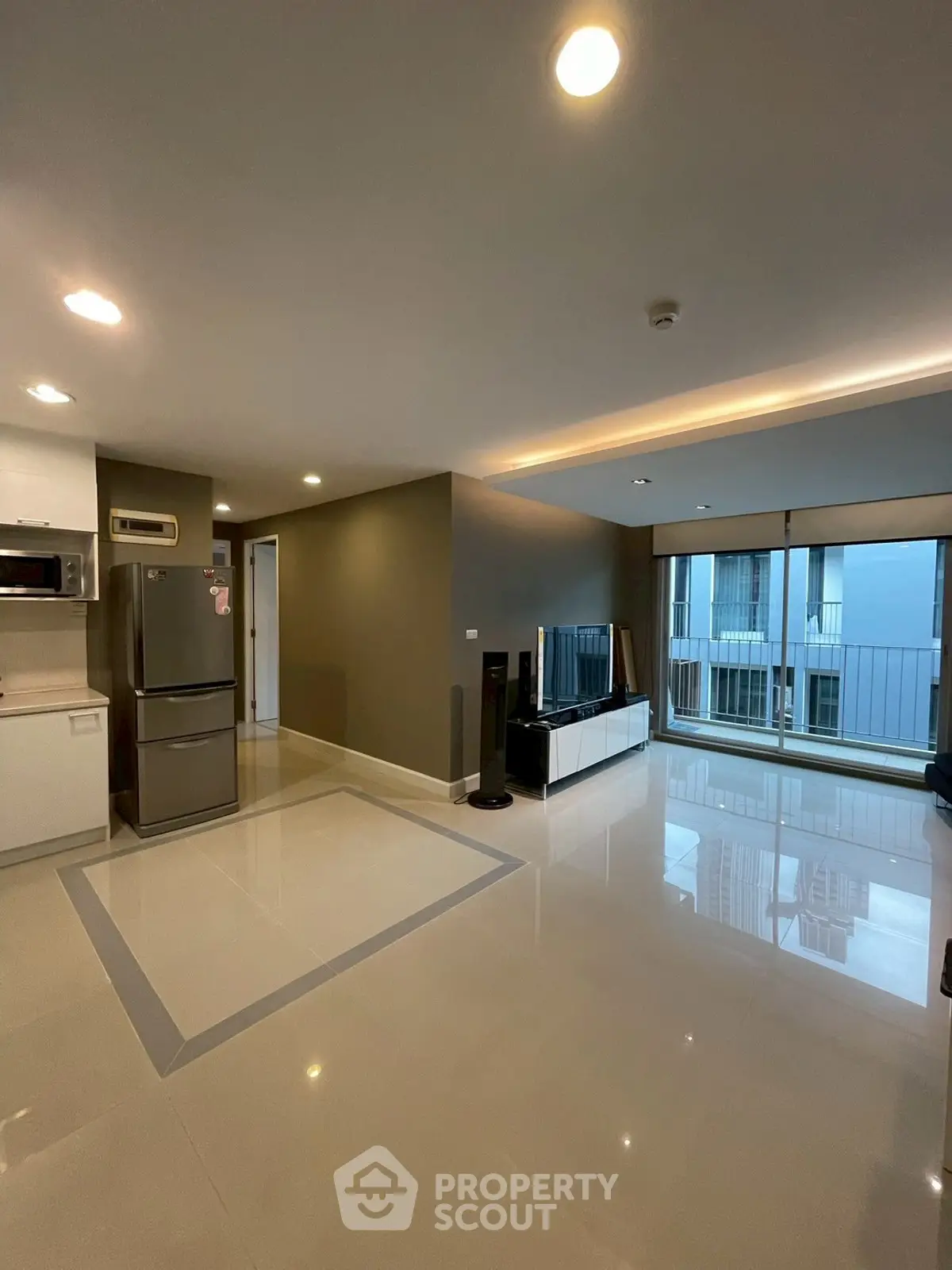 Spacious modern living room with open kitchen and large windows