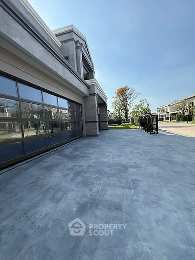 Luxurious modern building exterior with spacious patio and elegant design
