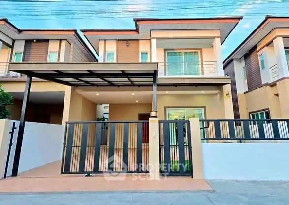 Modern two-story house with gated entrance and carport in a suburban neighborhood.