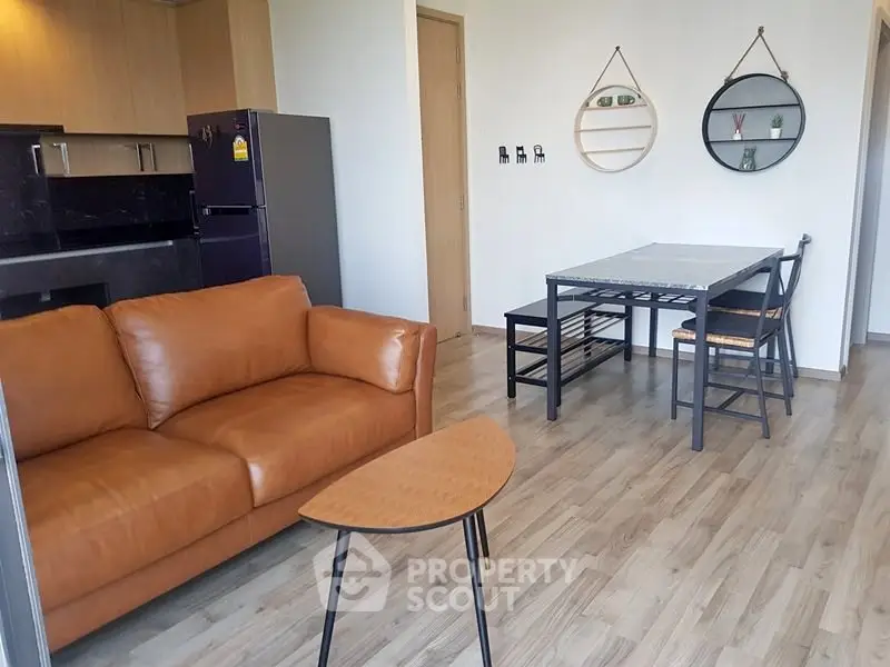 Modern living room with stylish furniture and open kitchen layout, perfect for urban living.