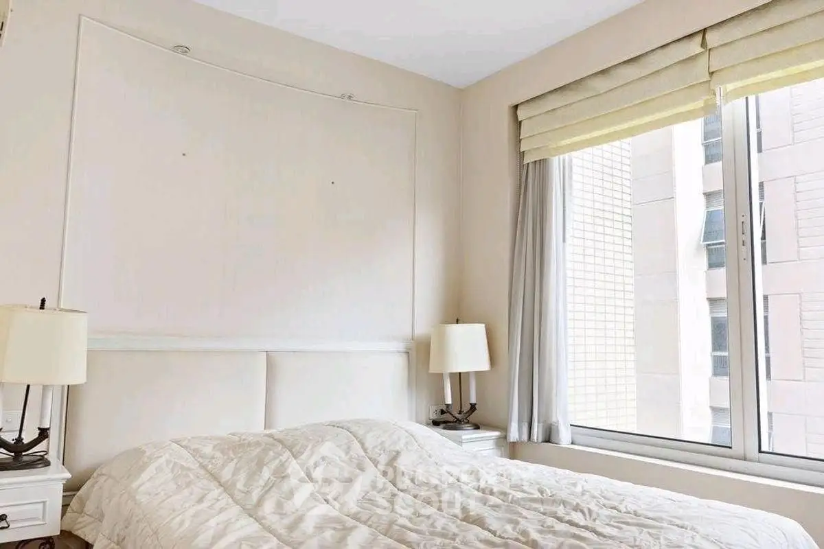 Bright and cozy bedroom with large window and modern decor