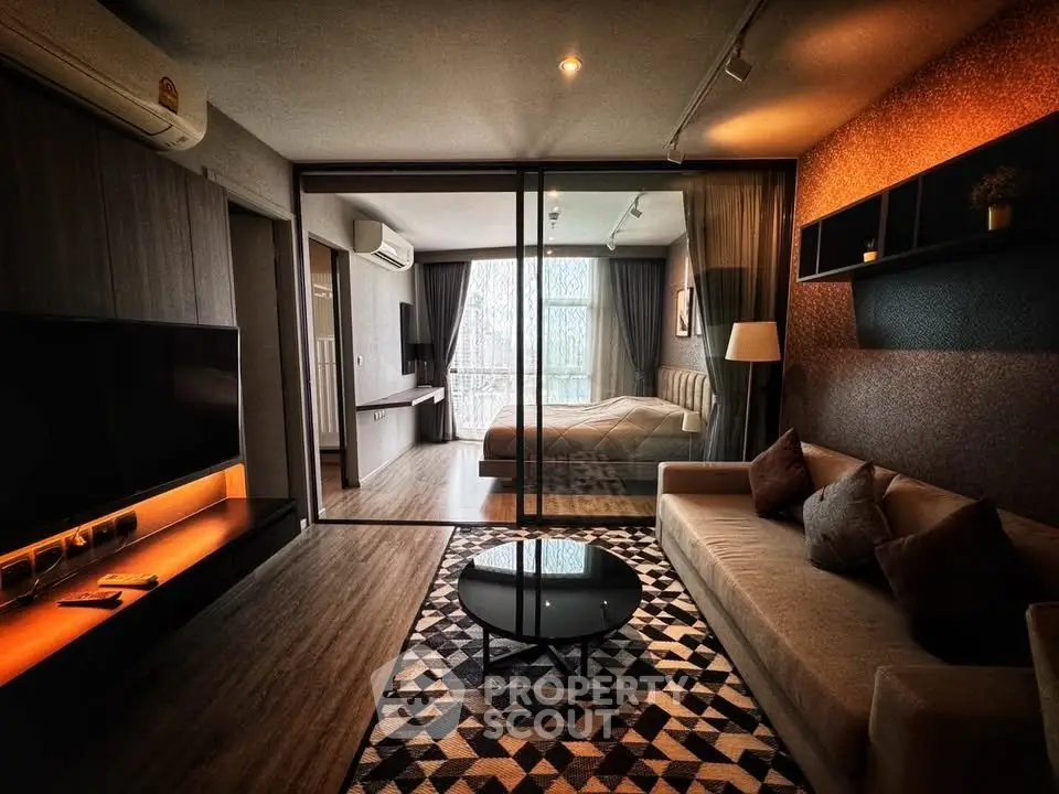 Modern living room with glass partition and cozy bedroom view