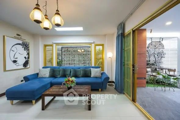 Stylish living room with blue sectional sofa and modern decor