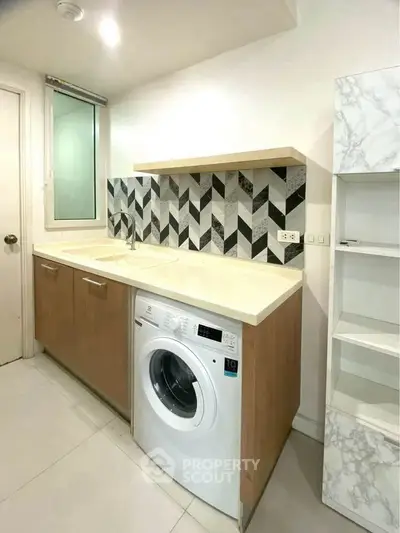 Modern kitchen with washing machine and stylish backsplash