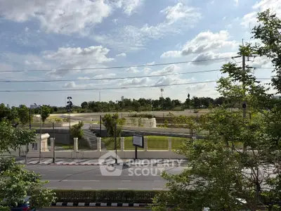 Scenic view of a modern park with lush greenery and clear skies, perfect for outdoor activities.