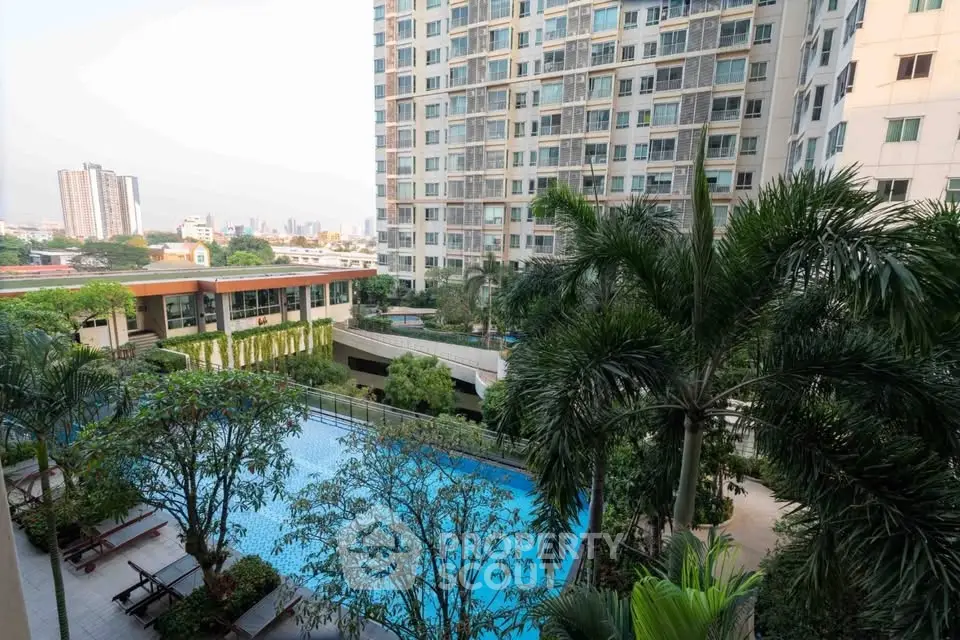 Luxurious condo with pool and lush garden view in urban setting.