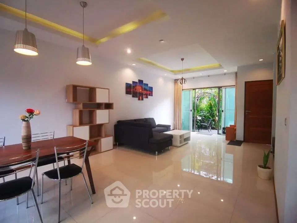 Spacious modern living room with elegant dining area and garden view.