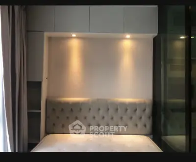 Modern bedroom with elegant lighting and tufted headboard