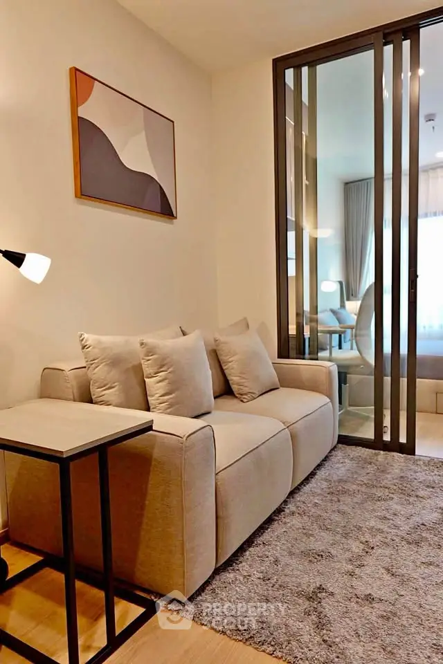 Modern living room with cozy beige sofa and stylish decor in a contemporary apartment.