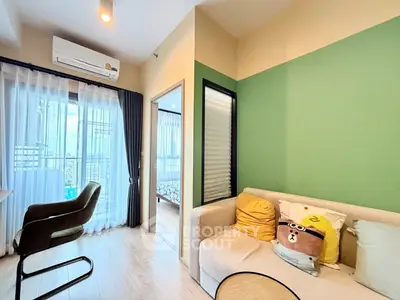 Cozy living room with modern decor and large window for natural light