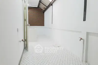 Spacious white bathroom with modern design and skylight
