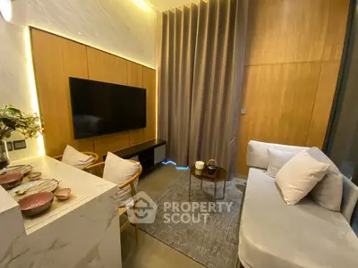 Modern living room with sleek design, featuring a wall-mounted TV, cozy sofa, and elegant dining area.