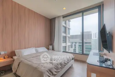 Modern bedroom with large window offering city view, featuring cozy bed and stylish decor.