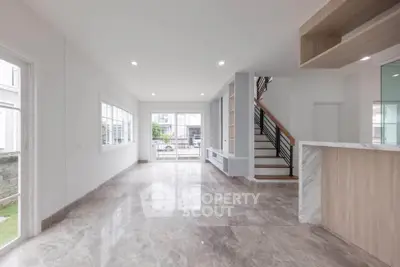 Spacious modern living room with marble flooring and large windows
