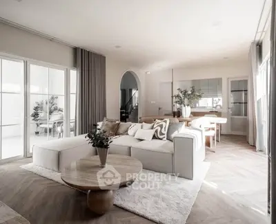 Luxurious open-plan living room with elegant decor and natural light