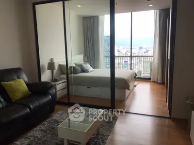 Modern apartment with glass-walled bedroom and stunning city view