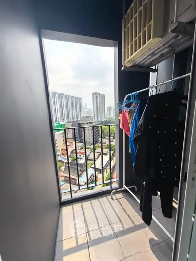 High-rise apartment balcony with city view and laundry area